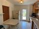 Practical kitchen with tiled floors, simple lighting, and a clear view to the outside at 1417 Terry Ave, Punta Gorda, FL 33980