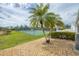 Spacious backyard with lawn and views of community tennis courts at 14281 Palm Ter, Port Charlotte, FL 33953