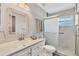 Well-lit bathroom featuring a decorative mirror and a shower with sliding doors at 14281 Palm Ter, Port Charlotte, FL 33953