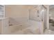 Bright bathroom featuring a soaking tub with shower and built-in shelving at 14281 Palm Ter, Port Charlotte, FL 33953