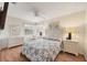 Bright bedroom with wood floors, ceiling fan, and two dressers and bedside tables at 14281 Palm Ter, Port Charlotte, FL 33953