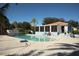 Inviting community pool surrounded by lounge chairs and tropical landscaping at 14281 Palm Ter, Port Charlotte, FL 33953