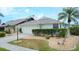 Inviting single-story home with a well-manicured lawn and a two-car garage in a desirable neighborhood at 14281 Palm Ter, Port Charlotte, FL 33953