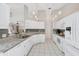 Bright kitchen features white cabinets, granite countertops, pendant lighting, and stainless steel appliances at 14281 Palm Ter, Port Charlotte, FL 33953