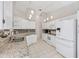 Bright kitchen features white cabinets, granite countertops, pendant lighting, and stainless steel appliances at 14281 Palm Ter, Port Charlotte, FL 33953