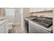Functional laundry room with side-by-side washer and dryer, plus shower at 14281 Palm Ter, Port Charlotte, FL 33953
