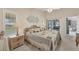 Relaxing main bedroom with ceiling fan, natural lighting, and sliding glass door to exterior at 14281 Palm Ter, Port Charlotte, FL 33953