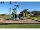 Colorful community playground with modern equipment and a soft landing surface at 14281 Palm Ter, Port Charlotte, FL 33953