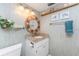 Bathroom showcasing granite countertop, decorative wall art, lighting, and stylish fixtures at 1651 Beach Rd # 311, Englewood, FL 34223