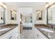 Hallway leading to Main bedroom features granite countertop sinks and mirrors at 1651 Beach Rd # 311, Englewood, FL 34223