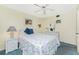 Cozy bedroom featuring nautical decor, ceiling fan, and comfortable furnishings creating a relaxing retreat at 1651 Beach Rd # 311, Englewood, FL 34223