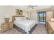 Comfortable bedroom with ceiling fan, balcony access and plenty of natural light at 1651 Beach Rd # 311, Englewood, FL 34223