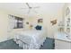 Nautical themed bedroom with carpet, a white wicker dresser, and ceiling fan at 1651 Beach Rd # 311, Englewood, FL 34223