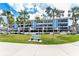 Beautifully landscaped building with mature palms offering serene coastal living at 1651 Beach Rd # 311, Englewood, FL 34223