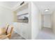 Bright kitchen features granite countertops, white cabinets, and pass-through to dining area at 1651 Beach Rd # 311, Englewood, FL 34223
