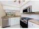 Well-equipped kitchen with stainless steel appliances, granite countertops, and ample cabinet space at 1651 Beach Rd # 311, Englewood, FL 34223