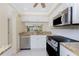 Well-lit kitchen featuring stainless steel appliances and lots of counter space at 1651 Beach Rd # 311, Englewood, FL 34223