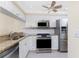 Bright kitchen features stainless appliances, granite countertops and ample cabinet storage at 1651 Beach Rd # 311, Englewood, FL 34223