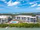 Aerial view of condos featuring a stunning pool, ample lounge seating, and easy water access at 1651 Beach Rd # 311, Englewood, FL 34223