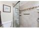Stand-up shower features light tile with decorative band and built-in shelves at 1651 Beach Rd # 311, Englewood, FL 34223