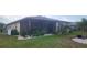Picture of a backyard featuring a screened patio and well maintained lawn at 171 Caddy Rd, Rotonda West, FL 33947