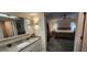 Bright bathroom with granite countertops, modern lighting, and access to the Primary bedroom at 171 Caddy Rd, Rotonda West, FL 33947