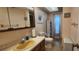 Well-lit bathroom with single sink vanity, toilet, and tiled floor at 171 Caddy Rd, Rotonda West, FL 33947