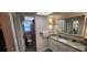Bathroom with a toilet and sink, featuring a mirror and tile floors at 171 Caddy Rd, Rotonda West, FL 33947