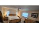Sun-filled bedroom with a wooden bed frame, side tables, and ample natural light at 171 Caddy Rd, Rotonda West, FL 33947