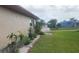 Exterior side view of a home with manicured landscaping, and a lush green lawn at 171 Caddy Rd, Rotonda West, FL 33947