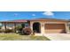 Charming single-story home featuring a well-maintained lawn, mature landscaping, and an attached garage at 171 Caddy Rd, Rotonda West, FL 33947
