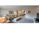 Spacious living room with leather sofa set and open access to the dining area at 171 Caddy Rd, Rotonda West, FL 33947