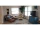 Cozy living room featuring neutral walls, carpeting, and wicker furniture near bright windows at 171 Caddy Rd, Rotonda West, FL 33947