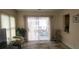 Bright living room with sliding glass doors leading to a screened porch with outdoor seating at 171 Caddy Rd, Rotonda West, FL 33947
