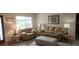 Comfortable living room featuring neutral-toned sofas, ottoman, and bright natural lighting at 171 Caddy Rd, Rotonda West, FL 33947
