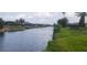 Beautiful canal view with well-maintained landscaping on both sides at 171 Caddy Rd, Rotonda West, FL 33947