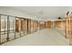 Spacious interior needs remodel, with exposed framing and fan, windows facing exterior at 1915 Michigan Av, Englewood, FL 34224