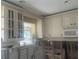 Bright kitchen with custom white cabinets and a view to the sunroom at 1977 Beach Rd # 87, Englewood, FL 34223