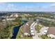 Aerial view of the condos, showcasing the waterfront setting, landscaping, and nearby golf course community at 202 Silver Lake Dr # 203, Venice, FL 34292