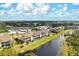 Panoramic aerial view of the condos with water views, lush greenery, and beautiful landscaping at 202 Silver Lake Dr # 203, Venice, FL 34292