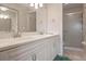 Clean bathroom featuring a double sink vanity with granite countertops and a glass-enclosed shower at 202 Silver Lake Dr # 203, Venice, FL 34292