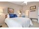 Comfortable bedroom with soft lighting, white bedspread and an ensuite bathroom at 202 Silver Lake Dr # 203, Venice, FL 34292