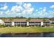 Waterfront condo complex with screened lanais, lush landscaping, and serene views of the adjacent waterway at 202 Silver Lake Dr # 203, Venice, FL 34292