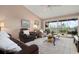Comfortable living room with sliders to a screened lanai and neutral decor at 202 Silver Lake Dr # 203, Venice, FL 34292