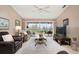 Spacious living room with a large TV, access to the screened-in lanai, and nice decor at 202 Silver Lake Dr # 203, Venice, FL 34292
