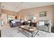 Cozy living room features a high ceiling, ceiling fan and an open view into the kitchen at 202 Silver Lake Dr # 203, Venice, FL 34292