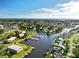 Expansive aerial view showcasing the neighborhood's waterfront homes along canals and a bay in the distance at 217 Rockwood Way, Englewood, FL 34223