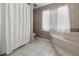 Bathroom with tiled shower, garden tub, and toilet for added convenience at 217 Rockwood Way, Englewood, FL 34223