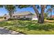 Well-maintained property showcasing lush green lawn and a meticulously cared for exterior at 217 Rockwood Way, Englewood, FL 34223
