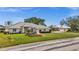 Charming home with well-maintained lawn, elegant landscaping, and a neutral-toned exterior at 217 Rockwood Way, Englewood, FL 34223